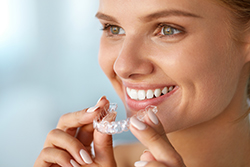 Woman Whitening Her Teeth
